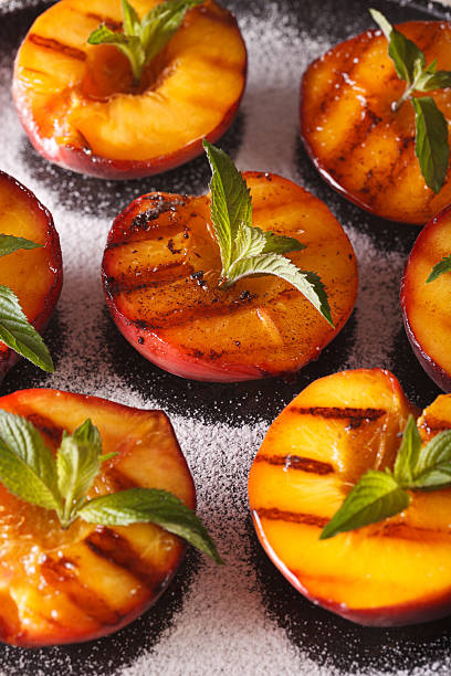 istock Grilled Peaches with powdered sugar and mint macro 636852640