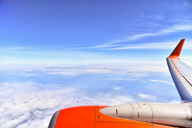 istock Wing of the plane on cloud and blue sky background 636852938
