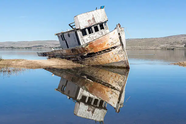 Photo of Point Reyes Shipwreck and reflections on a clear blue sky.