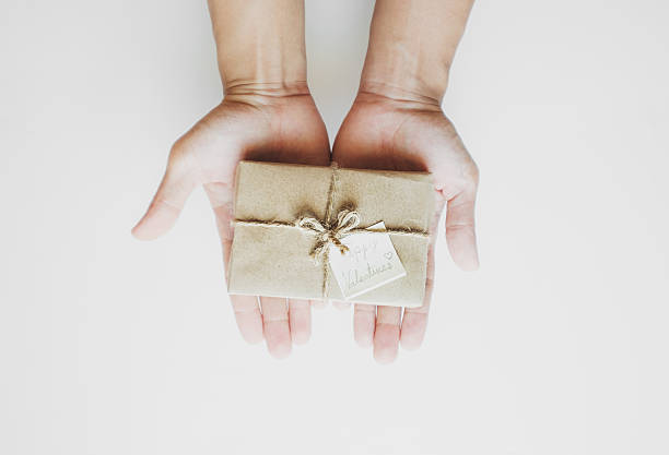 istock Hand holding gift box, with happy valentines day card 636854326