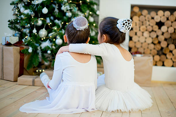 Two girls having fun on bed. Christmas
