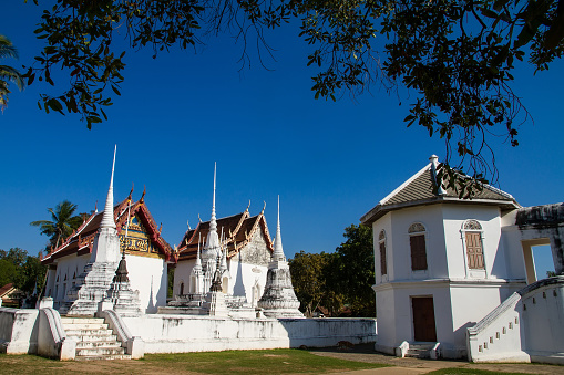 Wat Uposatharam Temple at noon under blue sky,Located along the banks of the Sakae Krang River in Uthai Thani, Thailand.