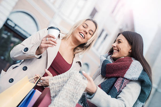 istock Young women shopping together 636856290