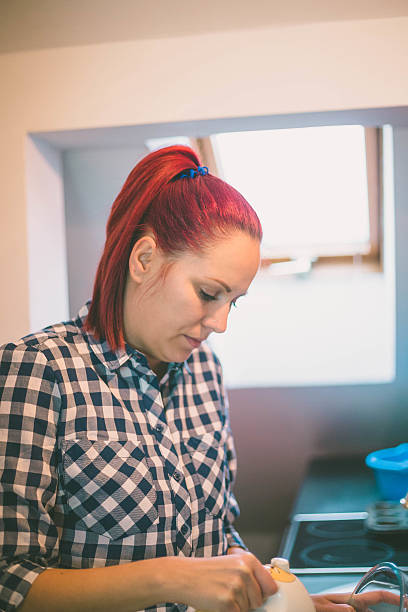 istock happy woman cooking on kitchen 636858182