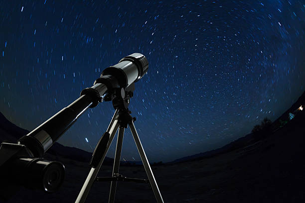 istock Telescope pointed to the clear night sky and stars 636858346