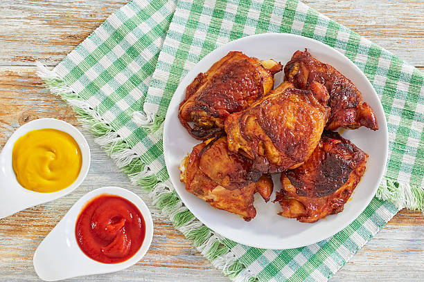 istock delicious fried chicken thigh on white plate on table cloth 636858750