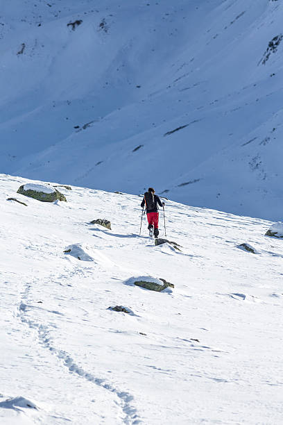 istock Hiker walks on snowy mountain 636858880