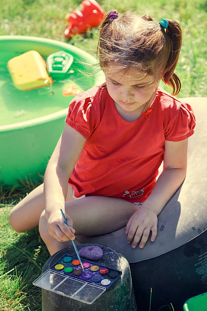 istock Little artist in summer garden. 636860788