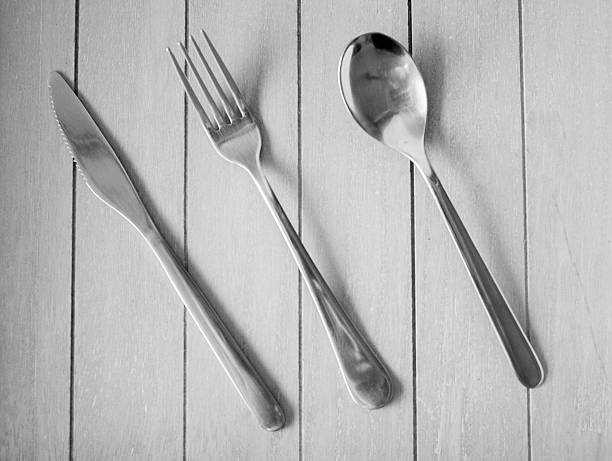 istock Spoon, knife and fork on wooden background 636861944