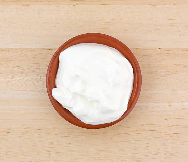 istock Sour cream in a small bowl on a wood table. 636862054