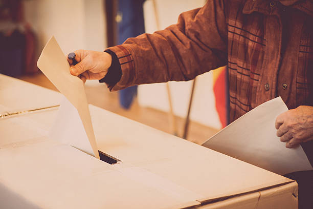 istock Person voting at polling station 636865726