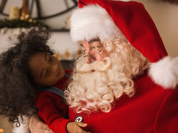 Santa Claus playing with cute child Santa Claus playing with cute African American child at home santa claus photos stock pictures, royalty-free photos & images