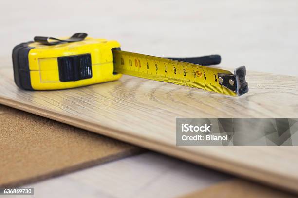 Measuring Tape On Laminate Floor Plank Stock Photo - Download Image Now - Apartment, Backgrounds, Business Finance and Industry
