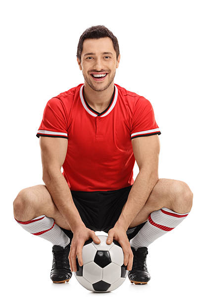 Happy football player with a ball