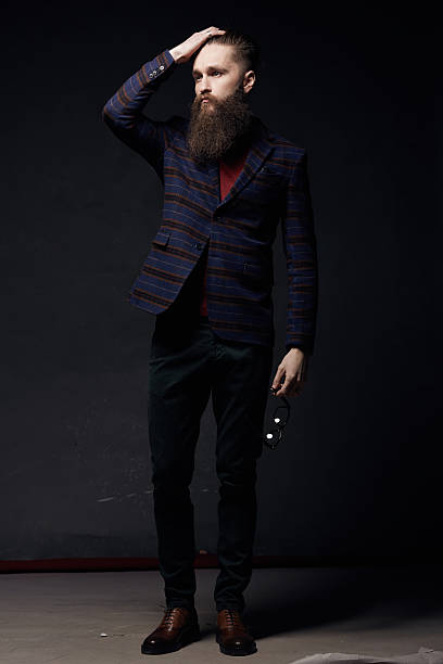 istock Sexy stylish man with beard in dark studio 636874530