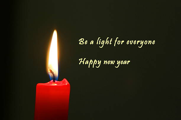 istock Red candle with dark background and english text 636879098
