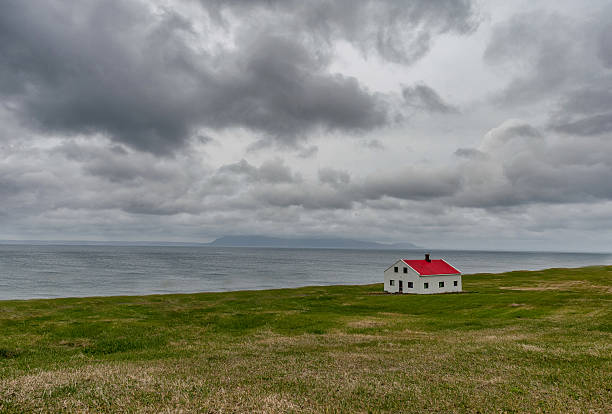 istock Iceland Landscape with Lonely Building. Cloudy Blue Sky 636879274
