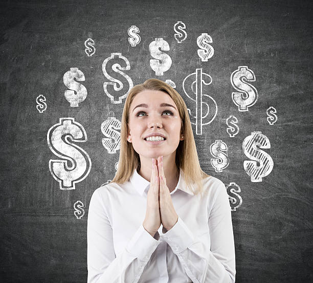 istock Woman dreaming about dollars, chalkboard 636879976