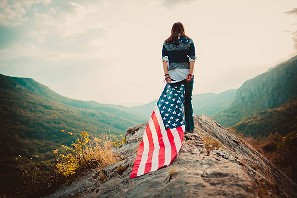 istock Girl holding american flag 636881764
