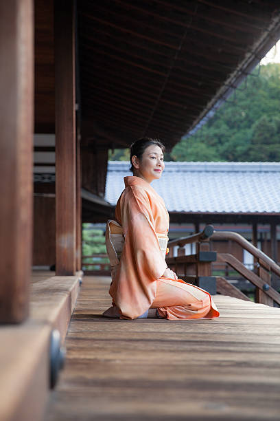 Japanese woman in Kimono sit on temple carridor Japanese woman in Kimono sit on temple carridor rinzai zen buddhism stock pictures, royalty-free photos & images