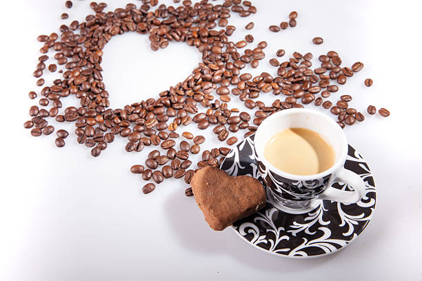 istock Heart make whit coffee beans and cup whit espresso. 636887452