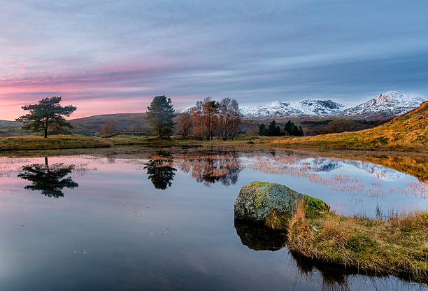 istock Kelly Hall Tarn Serene Sunset With Snowcapped Mountains. 636887832