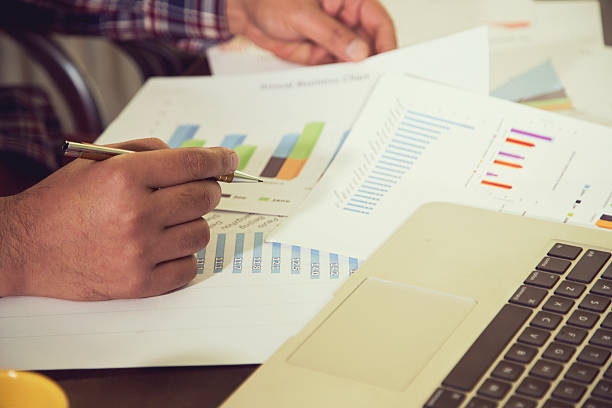 istock Businessman checking reports at office desk 636888656