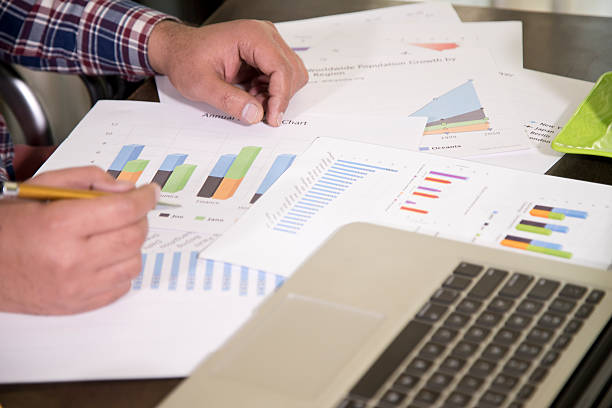 istock Businessman checking reports at office desk 636888776