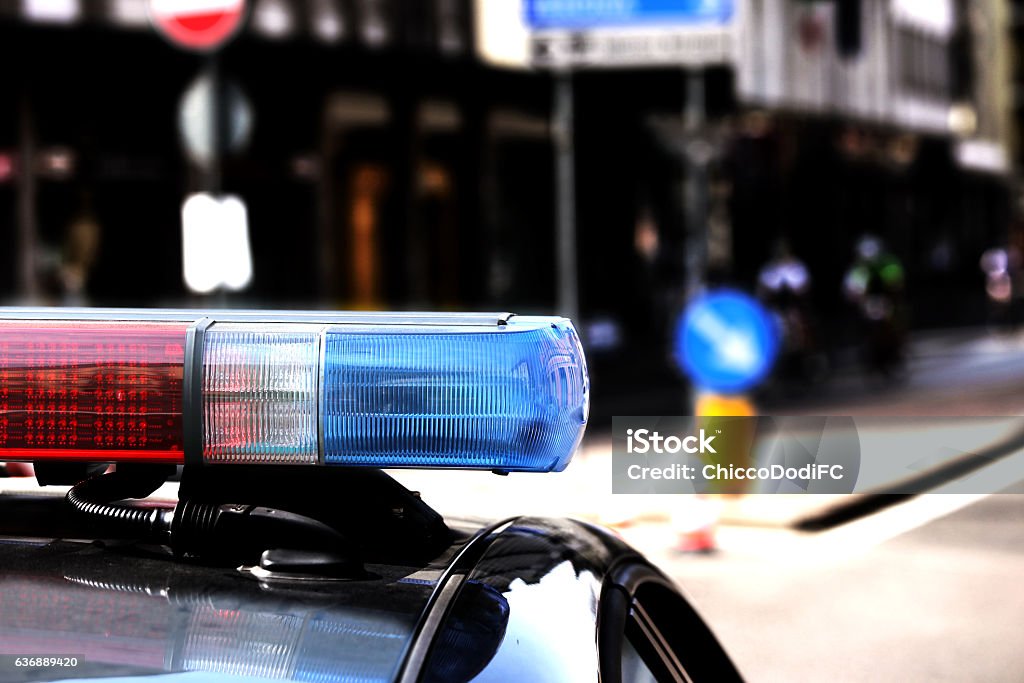 Red and blue flashing lights of the police car Red and blue flashing lights of the police car in the checkpoint at night Traffic Warden Stock Photo