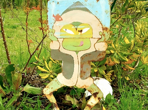 Tin frog in a garden.