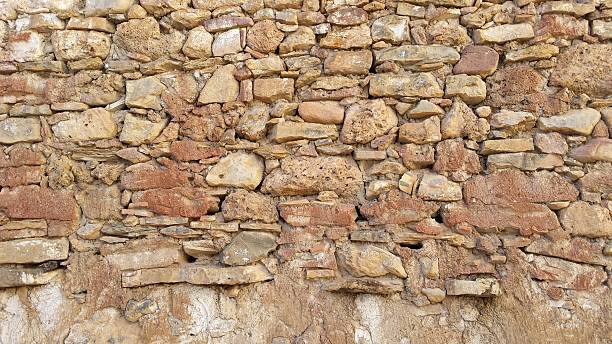 istock stone wall red pink and yellow 636891802