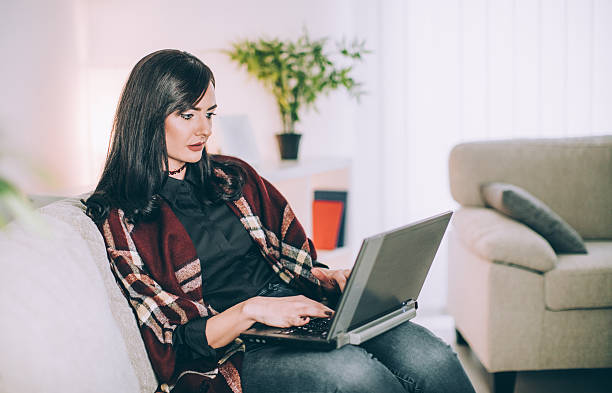 istock Happy girl using laptop at home 636894868