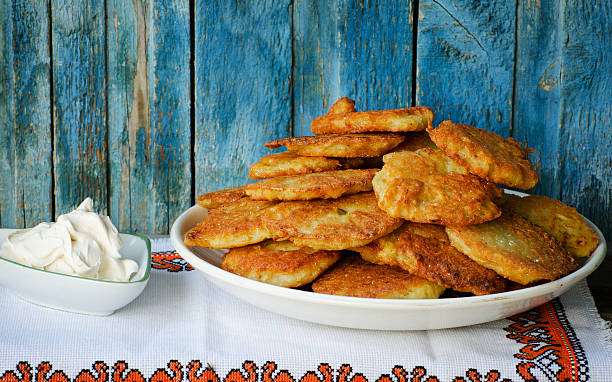 istock Potato fritters in a large dish, sour cream 636895196