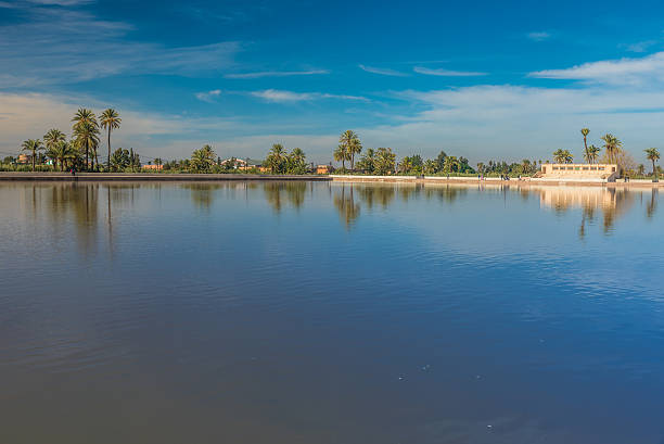 Ruins of the Saadian garden pavilion with the snow capped Atlas mountains in the background and the reflecting pool in the foreground, Menara Gardens, Marrakech, Morocco