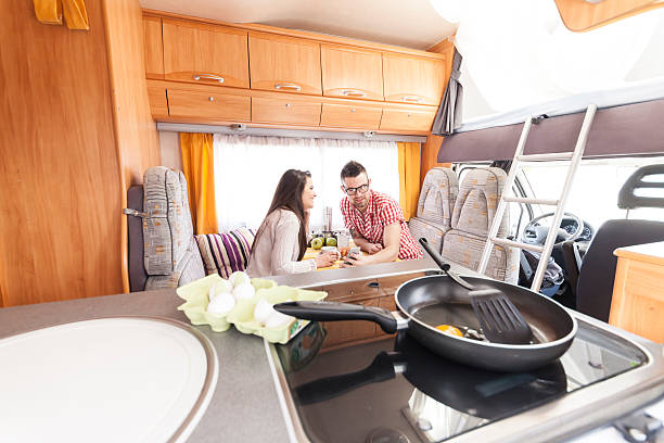 istock Young couple tourists having breakfast inside of a camper van 636899494