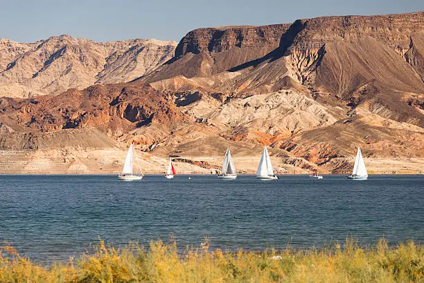 Mountains dominate the background with Sailboats moving along Lake Mead
