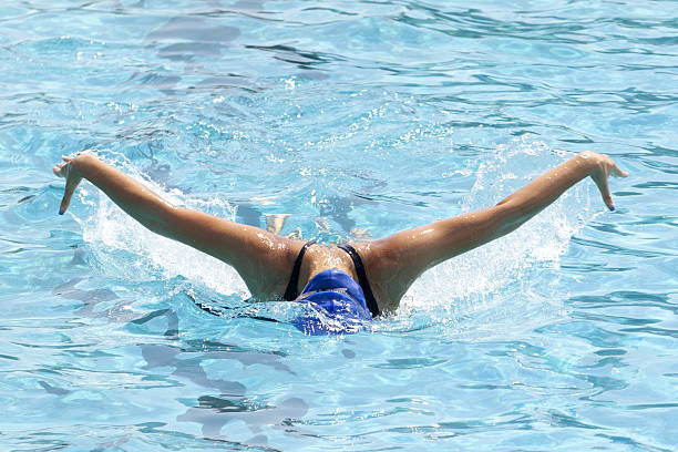 istock young woman swimming in the pool 636901290