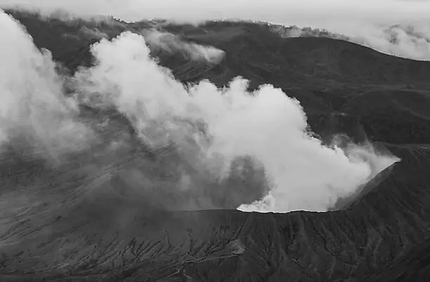 Artistic black and white volcano erupting