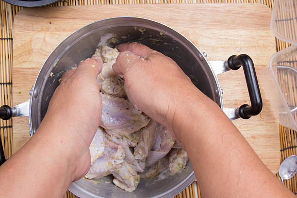 istock Chef mixing flour to chicken wings for cooking 636907920