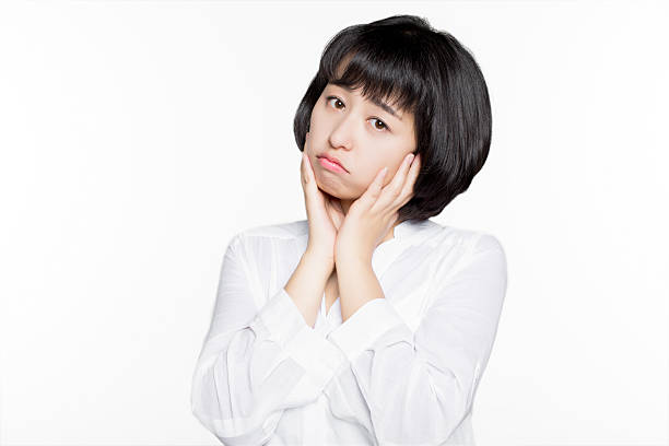 istock woman performing facial expression 636908848