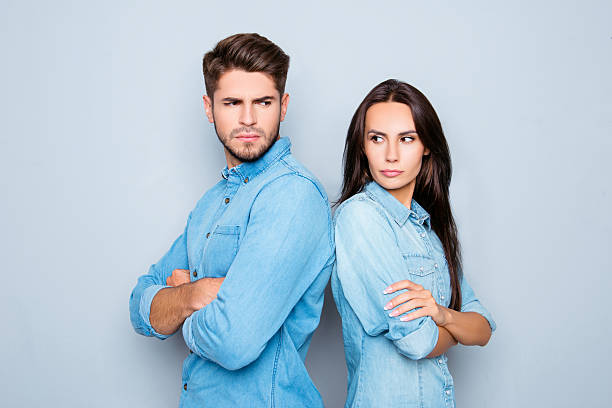 istock Serious man and woman  standing back to back after quarrel 636910568