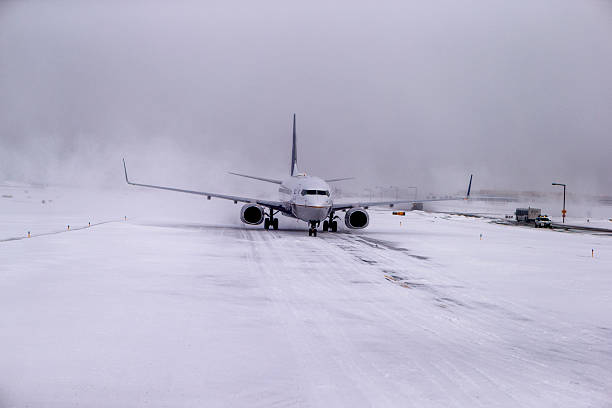 istock Airplane landing during a Snow storm 636912884
