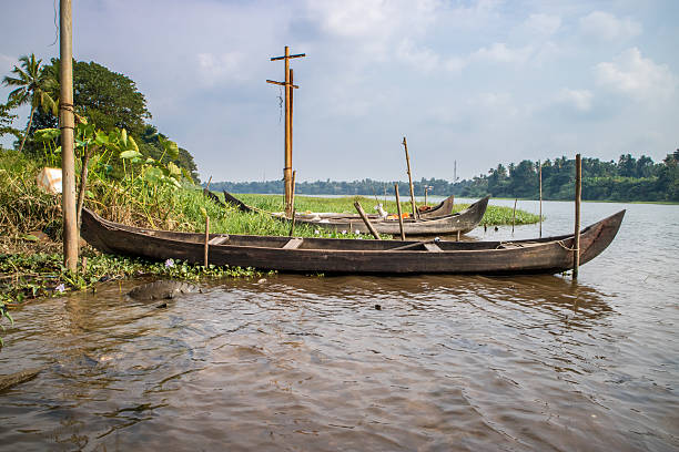 istock Wooden canoe on the shore with its motor 636913418
