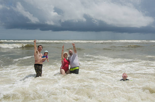 istock People in Surf Pointing Up 636915128