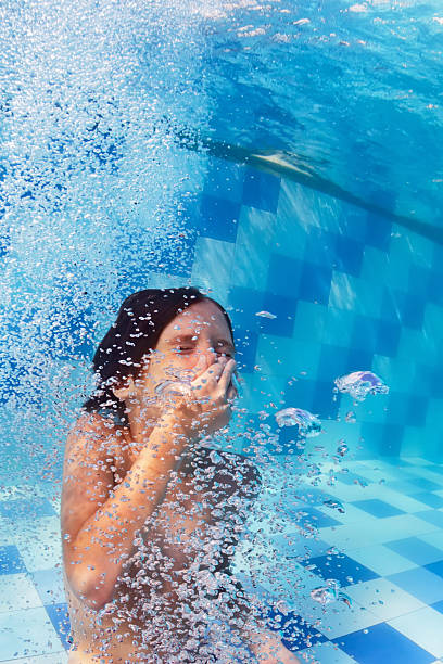 istock Child diving underwater in swimming pool 636915482