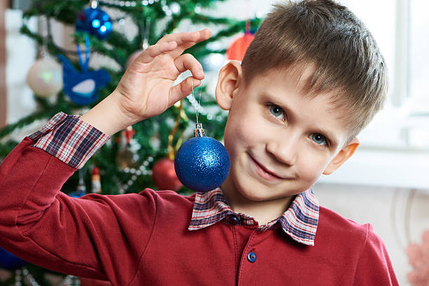 Happy child with Christmas toy ball close up