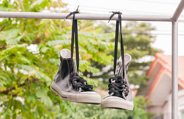 istock Hanging double retro shoes outdoor. 636930792
