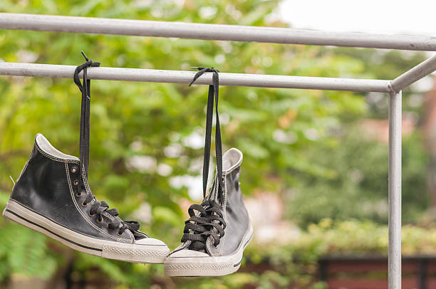 istock Hanging double retro shoes outdoor. 636931542