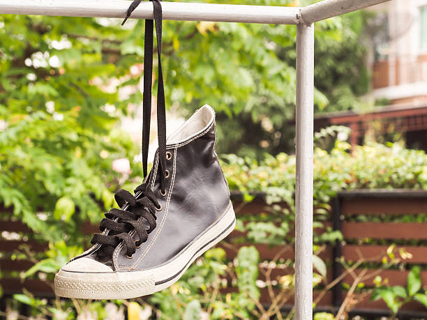 istock Hanging retro shoes outdoor alone. 636932200