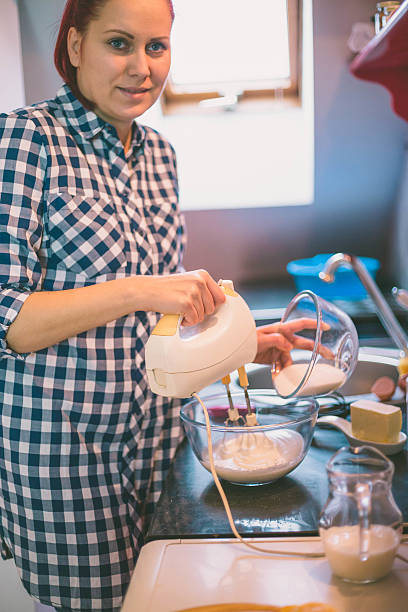 istock happy woman cooking on kitchen 636933358
